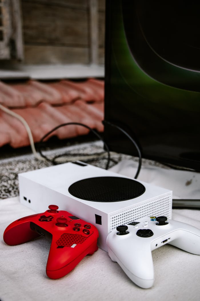 Xbox game console setup with vibrant red and white controllers, emphasizing wireless gaming.