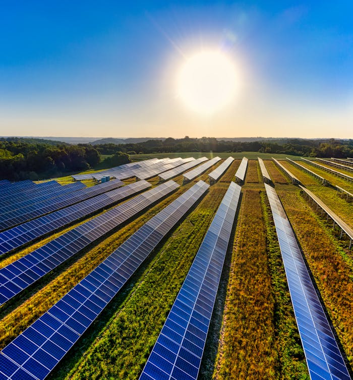 Aerial view of a solar farm in Red Wing, MN, with solar panels harnessing the sun's energy.